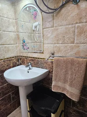 a bathroom with a sink and a mirror at Sheraton Plaza 319 in Hurghada