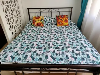 a bed with a quilt and pillows on it at Sheraton Plaza 319 in Hurghada
