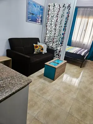 a living room with a couch and a table at Sheraton Plaza 319 in Hurghada