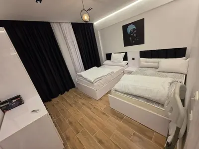 a bedroom with two beds and a mirror at Cozy Fully Furnished Apartment in Hurghada