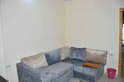 a grey couch in a living room at Mirage Bay Resort Aquapark Cap Ahmed Suite in Hurghada