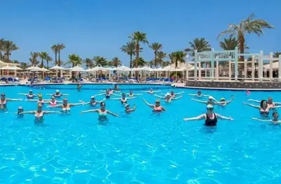 a group of people in the swimming pool at a resort at Mirage Bay Resort Aquapark Cap Ahmed Suite in Hurghada