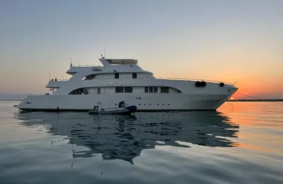 a large yacht in the water with a small boat at Yacht Aml-Hayaty in Hurghada