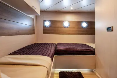 two beds in a small room with two windows at Yacht Aml-Hayaty in Hurghada