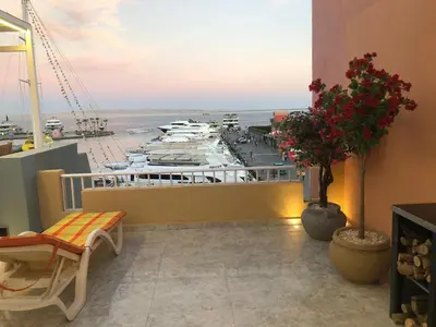 a balcony with a view of the ocean and boats at مارينا الغردقه in Hurghada