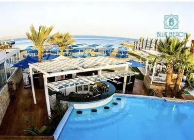 a resort with a large swimming pool next to the ocean at مارينا الغردقه in Hurghada