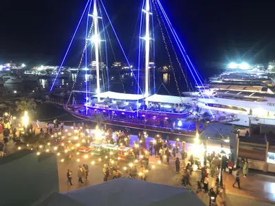 a group of people standing in front of a boat at night at مارينا الغردقه in Hurghada