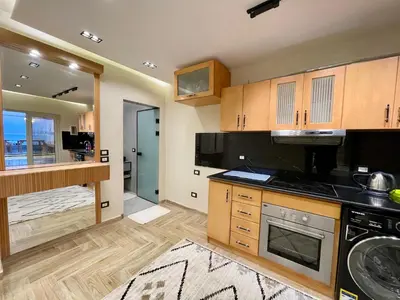 a kitchen with wooden cabinets and a stove top oven at مارينا الغردقه in Hurghada