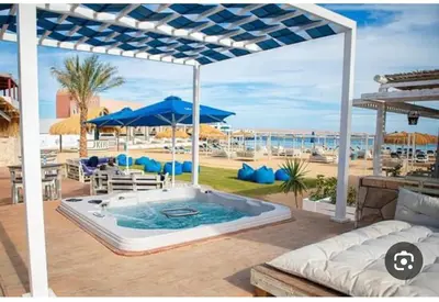 a hot tub on a patio with a view of the beach at مارينا الغردقه in Hurghada