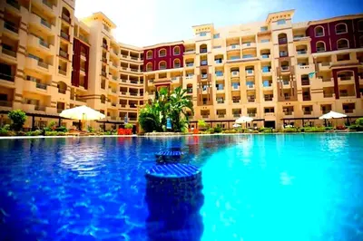a large swimming pool in front of a building at For Rent Florenza Khamsin Residential Apartment in Hurghada