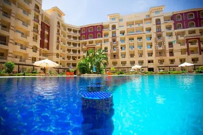 a large swimming pool in front of a building at For Rent Florenza Khamsin Residential Apartment in Hurghada
