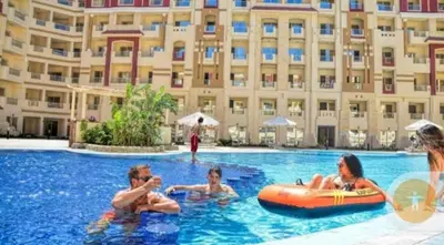 a group of people in a swimming pool at a hotel at For Rent Florenza Khamsin Residential Apartment in Hurghada