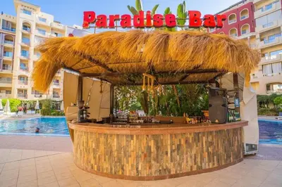 a bar in a resort with a straw roof at For Rent Florenza Khamsin Residential Apartment in Hurghada
