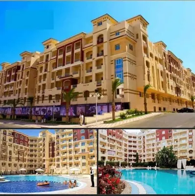 a building and a swimming pool in front of a building at For Rent Florenza Khamsin Residential Apartment in Hurghada