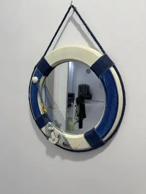 a mirror is hanging on a wall at شقه لك ب الكامل فندقي in Safaga