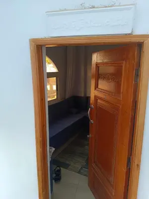 a door into a room with a couch behind it at venti house1 in Nag` el-Ramla