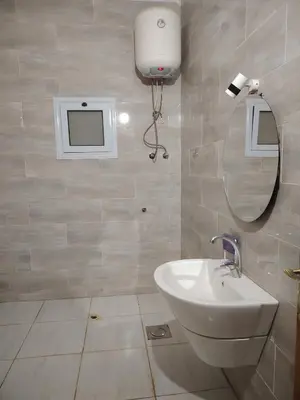 a bathroom with a white sink and a mirror at venti house1 in Nag` el-Ramla