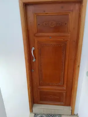 a wooden door with a handle in a hallway at venti house1 in Nag` el-Ramla