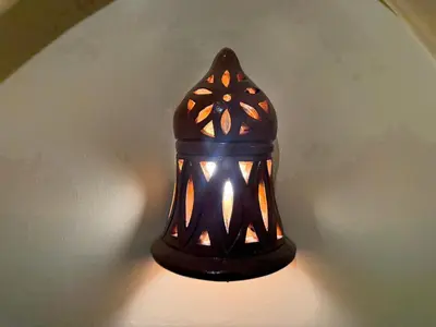 a black lamp is turned on on a wall at Temple Of The Golden Sun in Luxor