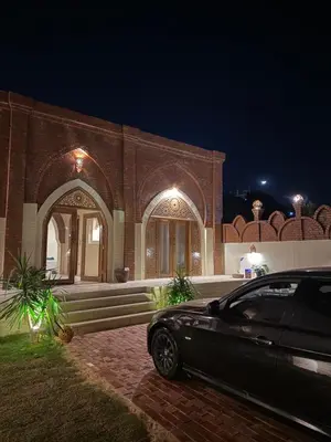 a car parked in front of a building at night at Temple Of The Golden Sun in Luxor