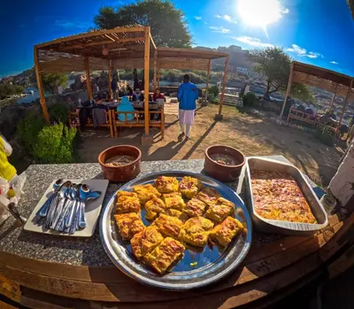 a table topped with food on top of a table at ASSINGAR Island in Aswan