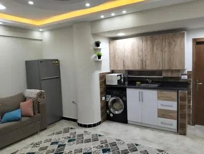a living room with a couch and a kitchen at البرنسيسة in Hurghada