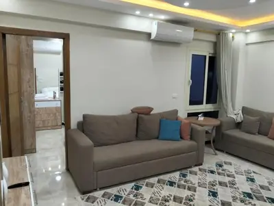 a living room with a couch and a table at البرنسيسة in Hurghada