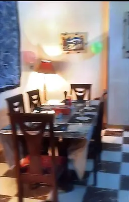 a blurry picture of a dining room table and chairs at Sphinx in Al Karnak