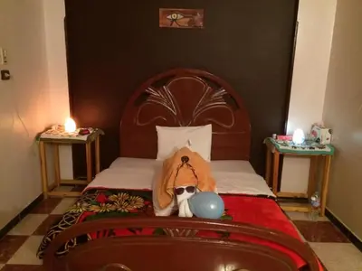 a bedroom with a bed with a dog wearing sunglasses at Sphinx in Al Karnak