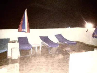 a group of chairs sitting around a table at night at Sphinx in Al Karnak