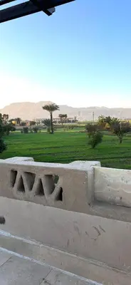 a stone wall with a view of a field at Yuhan's Bed & Breakfast in Al Karnak