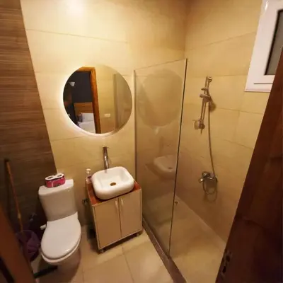 a bathroom with a toilet and a shower and a sink at Entire Oasis Villa - Heart of Ancient Luxor in Luxor