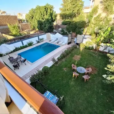 an aerial view of a backyard with a swimming pool at Entire Oasis Villa - Heart of Ancient Luxor in Luxor