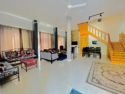 a living room with couches and a dining room at Entire Oasis Villa - Heart of Ancient Luxor in Luxor