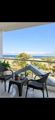 two chairs and a table on a balcony with a view at Luxury Panorama Sea View Residence with sky pool in Hurghada