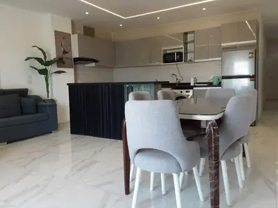 a kitchen and living room with a table and chairs at Luxury Panorama Sea View Residence with sky pool in Hurghada