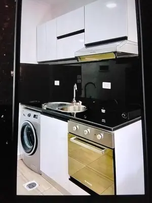 a kitchen with a sink and a washing machine at Hurghada Pool & See View Studio in Hurghada
