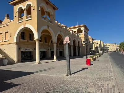 a building on a street with a street sign in front at Panorama view in Hurghada