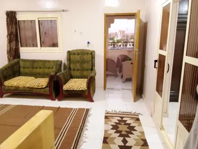 a living room with two chairs and a couch at D Guest house in Nag` el-Ramla
