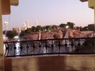 a view of a city from a balcony at D Guest house in Nag` el-Ramla