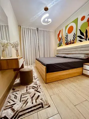 a bedroom with a bed and a rug at ALDAU village mall in Hurghada