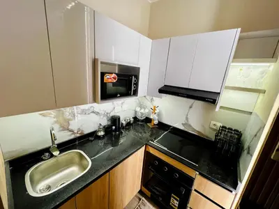 a small kitchen with a sink and a microwave at ALDAU village mall in Hurghada