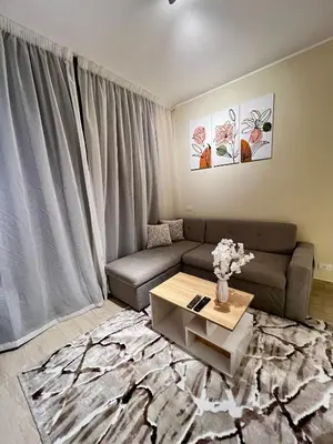 a living room with a couch and a coffee table at ALDAU village mall in Hurghada