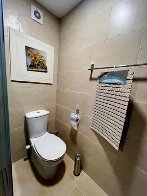 a bathroom with a toilet and a towel rack at ALDAU village mall in Hurghada