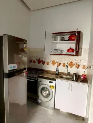 a kitchen with a sink and a washing machine at بيت علي النيل مباشره في الاقصر in Jazīrat al ‘Awwāmīyah