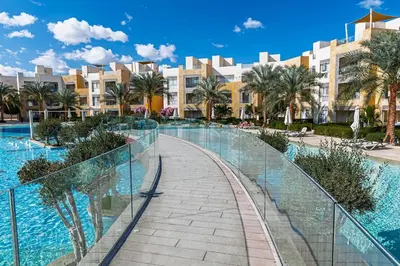 a walkway in front of a resort with a swimming pool at Serenity Pool View Holiday Home in Hurghada
