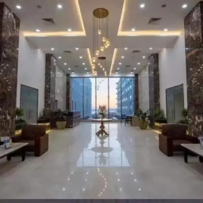 a lobby with couches and tables and a large window at scandic Beach Hurghada in Hurghada