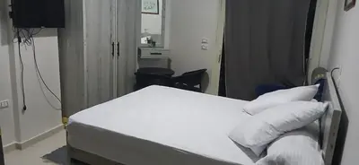 a hospital room with a bed with white sheets and pillows at شقه بمنتجع كذابلانكا in Hurghada