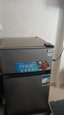a pizza box sitting on top of a refrigerator at شقه بمنتجع كذابلانكا in Hurghada