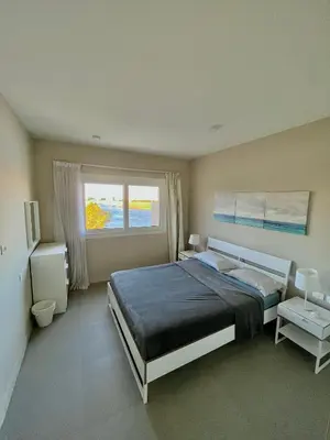 a bedroom with a large bed and a window at Cozy 1-bedroom Joubal lagoon apartment in Hurghada
